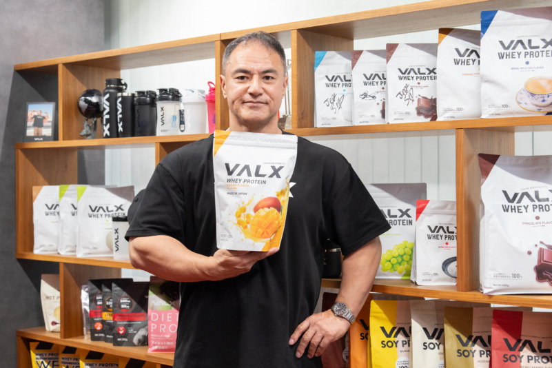 VALXのプロテイン商品を手に持つ山本義徳さん
